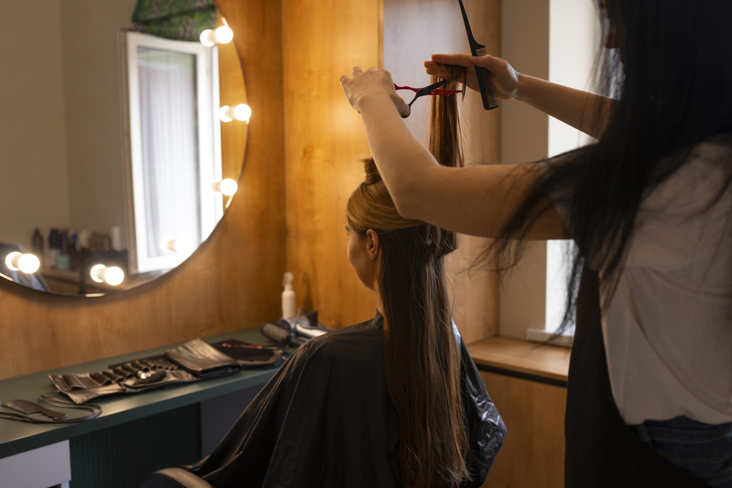 female-client-getting-her-hair-cut-hairdresser